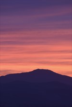 USA, Colorado, Denver, Mountain range with colorful sky at dusk