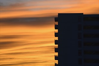 Silhouette of apartment building at dusk