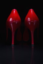 Red shoes against black background