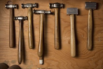 Collection of hammers lying on wood