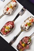 Sushi on metal spoons