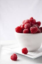 Raspberries in white cup