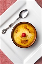 Creme brulee in bowl on white plate