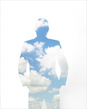 Composite image of clouds and silhouette of man.