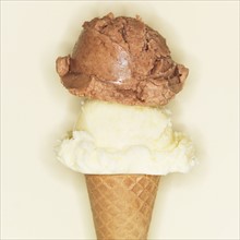Vanilla and chocolate ice creams in cone.