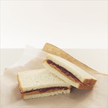 Peanut butter and jelly sandwiches on wrapping paper.