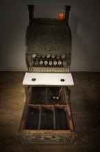 Antique cash register with open drawer.