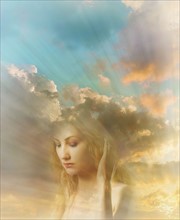 Face of young woman with sunrays and cloudy sky in background.