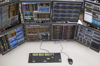 Desk with arrangement of computer monitors.