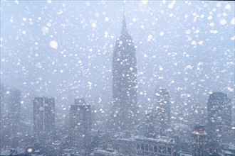 USA, New York State, New York City, Empire State Building and city skyline in snow.