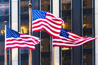 USA, New York, American flags in front of office building