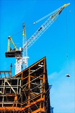 Crane at construction site against clear sky