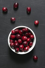 Cranberries in bowl and on table