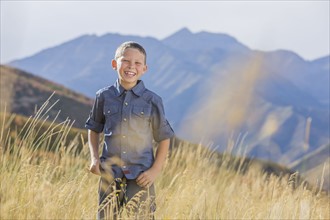 USA, Utah, Provo, Boy (6-7) standing in field
