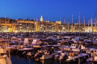 France, Provence-Alpes-Cote d'Azur, Marseille, Crowded Vieux port - Old Port at dusk