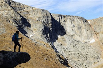USA, Colorado, Silhouette of hiker on rock ledge along Chicago Lakes Trail in Mount Evans Wilderness Area