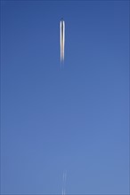 Low angle view of commercial airplane flying against blue sky