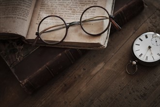 Antique book, watch and eyeglasses.