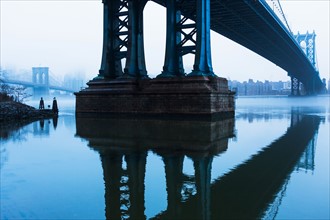 USA, New York, New York City, Manhattan, Brooklyn Bridge over East River in fog