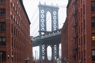 USA, New York, New York City, Manhattan, Brooklyn Bridge between buildings