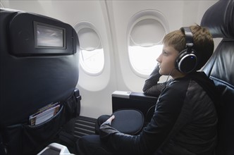 Boy watching tv in aero plane