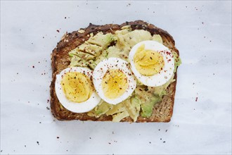 Toasted bread with avocado and hard boiled egg