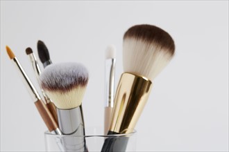 Various make up brushes in glass