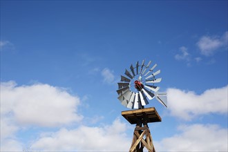 Old windmill against cloudy sky
