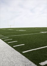 Overcast sky above american football field and goal post