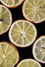 Close up of dried lemon slices on black background