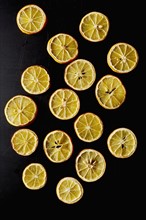 Dried lemon slices on black background