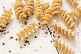 Pasta and quinoa on white background