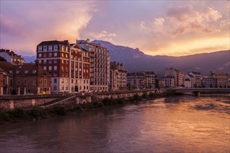 France, Auvergne-Rhone-Alpes, Grenoble, Grenoble architecture along Isere River seen at sunset