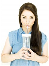 Woman wearing blue top drinking water from drinking glass