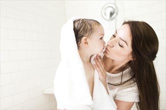 Mother kissing son (4-5)  in bathroom