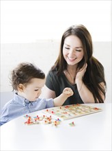 Mother playing alphabet game with son (4-5)