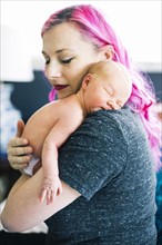 Mother holding newborn son (2-5 months)