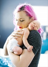 Mother embracing newborn son (2-5 months)