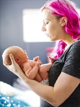 Mother holding newborn son (2-5 months)