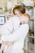 Portrait of mother embracing daughter ( 12-17 months )