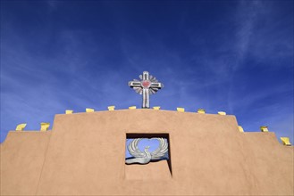 USA, New Mexico, Chimayo, Religious symbols on adobe wall