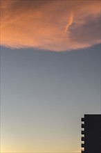 Silhouette of apartment building at dusk