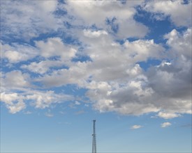White clouds over communications tower