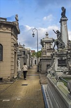 Argentina, Buenos Aires, Woman walking through Recoleta Cemetery