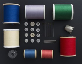Studio shot of colorful sewing tools on black background
