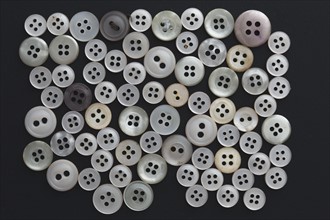 Studio shot of grey buttons on black background