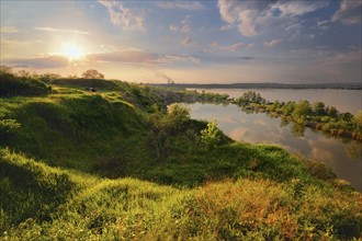 Ukraine, Dnepropetrovsk, Landscape with pond and hills at sunset