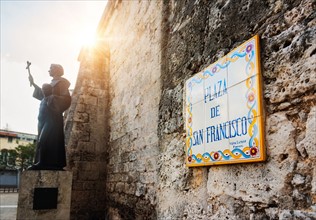 Cuba, Havana, Plaza De San Francisco, Tile sign next to statue of Francis of Assisi