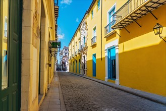 Cuba, Havana, Street with yellow houses