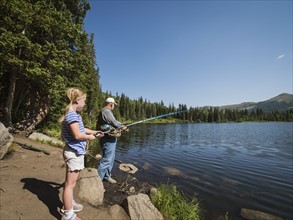 USA, Utah, Lake City, Girl (4-5) with grandfather fishing in lake